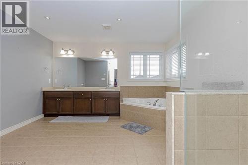 Full bath featuring double vanity, a garden tub, a stall shower, and light tile patterned floors - 2 Doon Creek Street, Kitchener, ON - Indoor Photo Showing Bathroom