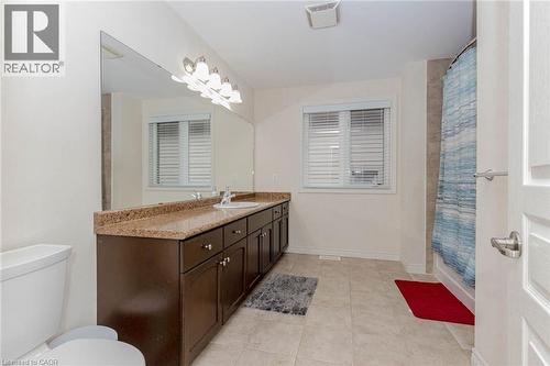 Full bathroom featuring vanity, a shower with shower curtain, and light tile patterned flooring - 2 Doon Creek Street, Kitchener, ON - Indoor Photo Showing Bathroom