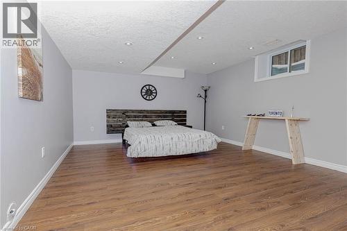 Bedroom featuring wood finished floors and a textured ceiling - 2 Doon Creek Street, Kitchener, ON - Indoor Photo Showing Bedroom