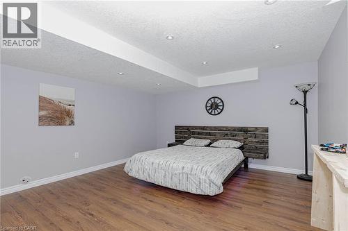 Bedroom with dark wood-type flooring, a textured ceiling, and recessed lighting - 2 Doon Creek Street, Kitchener, ON - Indoor Photo Showing Bedroom
