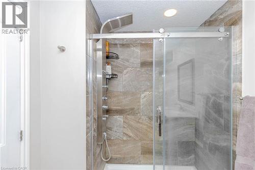 Bathroom with a stall shower and a textured ceiling - 2 Doon Creek Street, Kitchener, ON - Indoor Photo Showing Bathroom