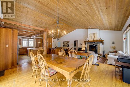 Tounge & Groove Vaulted Ceiling - 397 Silver Birch Drive, Tiny, ON - Indoor Photo Showing Dining Room With Fireplace