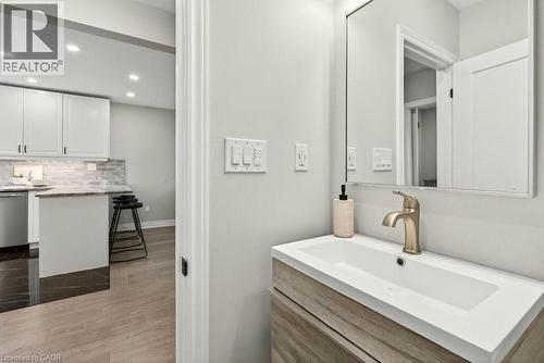 Bathroom featuring vanity, recessed lighting, dark wood-style flooring, and tasteful backsplash - 237 East 32Nd Street, Hamilton, ON - Indoor
