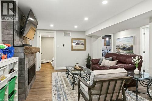 Living area with a tiled fireplace, light wood-style floors, and recessed lighting - 237 East 32Nd Street, Hamilton, ON - Indoor