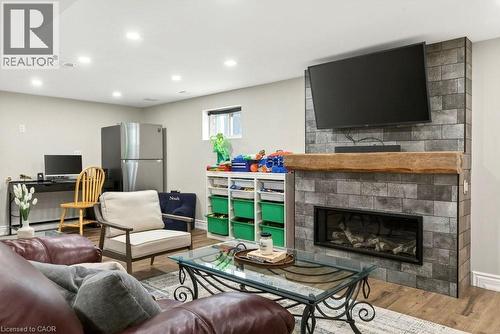 Living area featuring wood finished floors, recessed lighting, and a large fireplace - 237 East 32Nd Street, Hamilton, ON - Indoor Photo Showing Living Room With Fireplace