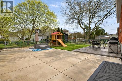 Fenced backyard featuring a patio area, a playground, outdoor dining space, and grilling area - 237 East 32Nd Street, Hamilton, ON - Outdoor