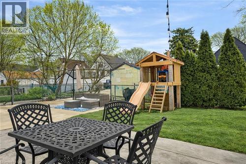 Fenced backyard with outdoor dining area, a playground, and a patio - 237 East 32Nd Street, Hamilton, ON - Outdoor With Deck Patio Veranda