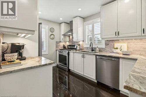 Kitchen with white cabinetry, light stone counters, and recessed lighting - 237 East 32Nd Street, Hamilton, ON - Indoor Photo Showing Kitchen With Upgraded Kitchen