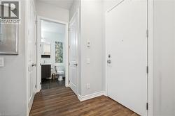 Entryway featuring dark wood finished floors and baseboards - 