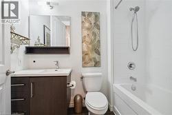 Bathroom with vanity and bathtub / shower combination - 