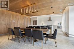 Dining room featuring wooden ceiling, light wood-style floors, and wooden walls - 