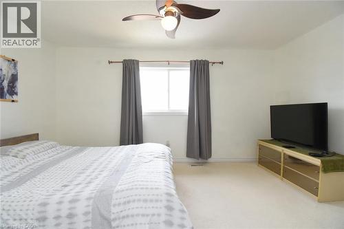 Carpeted bedroom with ceiling fan and baseboards - 142 Hawkswood Trail, Hamilton, ON - Indoor Photo Showing Bedroom