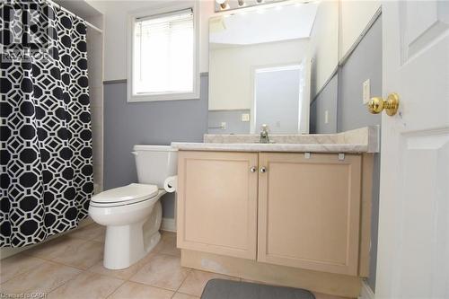 Bathroom featuring vanity, light tile patterned floors, and curtained shower - 142 Hawkswood Trail, Hamilton, ON - Indoor Photo Showing Bathroom