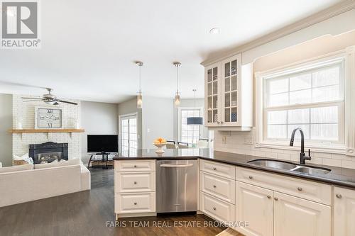 5 Bailey Crescent, Tiny, ON - Indoor Photo Showing Kitchen With Fireplace With Double Sink