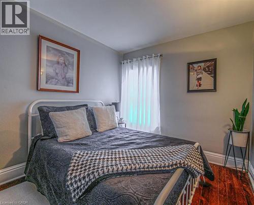 Bedroom with baseboards and dark wood-type flooring - 81 Beechwood Avenue, Hamilton, ON - Indoor Photo Showing Bedroom