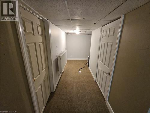 Corridor with a paneled ceiling and dark carpet - 170 Stewartdale Avenue, Hamilton, ON - Indoor Photo Showing Other Room
