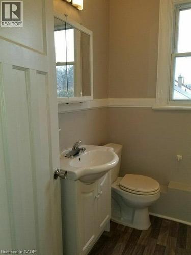 Half bathroom featuring vanity and dark wood-style flooring - 170 Stewartdale Avenue, Hamilton, ON - Indoor Photo Showing Bathroom
