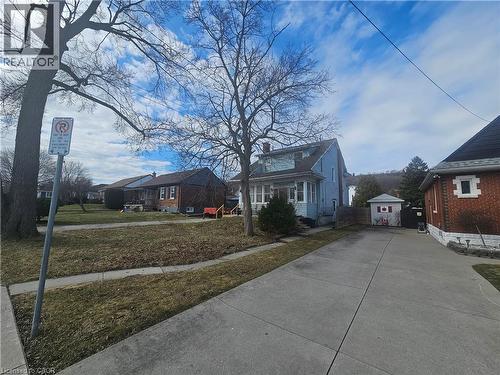 View of front facade with a front yard, a residential view, and an outbuilding - 170 Stewartdale Avenue, Hamilton, ON - Outdoor