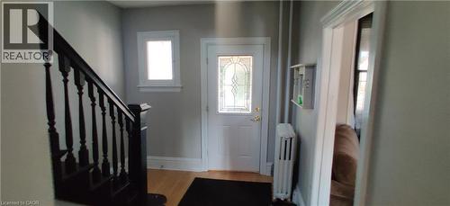 Foyer featuring radiator heating unit and light wood-type flooring - 170 Stewartdale Avenue, Hamilton, ON - Indoor Photo Showing Other Room