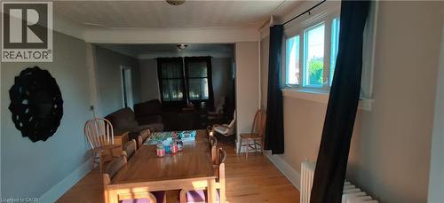 Dining room with light wood-type flooring and radiator heating unit - 170 Stewartdale Avenue, Hamilton, ON - Indoor