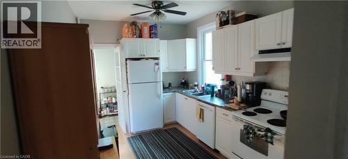 Kitchen with white appliances, a ceiling fan, white cabinets, and extractor fan - 170 Stewartdale Avenue, Hamilton, ON - Indoor Photo Showing Kitchen