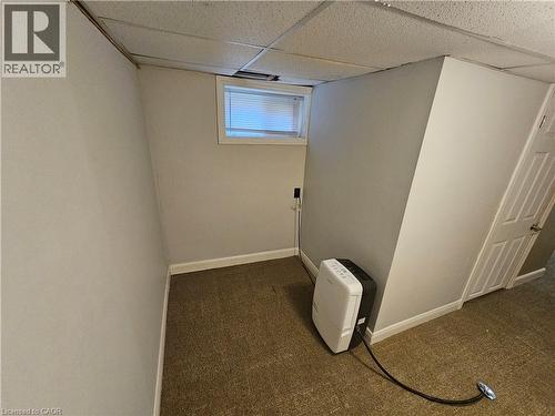 Basement with dark colored carpet and a paneled ceiling - 170 Stewartdale Avenue, Hamilton, ON - Indoor