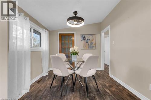 Dining area featuring dark wood-style floors and lofted ceiling - 77 Lawfield Drive, Hamilton, ON - Indoor Photo Showing Dining Room