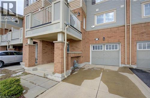 Doorway to property with brick siding, driveway, and an attached garage - 9 Outlook Terrace, Kitchener, ON - Outdoor With Balcony With Exterior