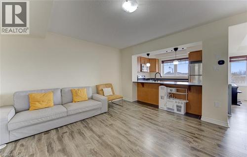 Living room featuring light wood-style flooring and baseboards - 9 Outlook Terrace, Kitchener, ON - Indoor