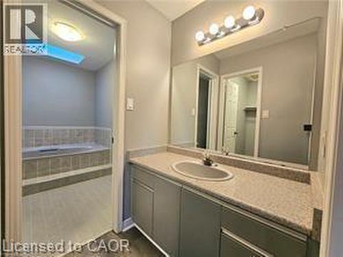 Bathroom with vanity and dark wood-style flooring - 486 Dicenzo Drive, Hamilton, ON - Indoor Photo Showing Bathroom