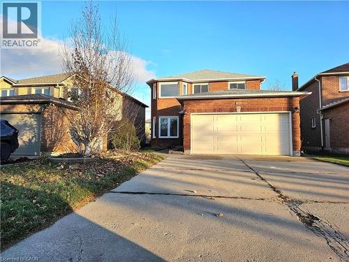 View of front facade featuring concrete driveway, brick siding, and a garage - 486 Dicenzo Drive, Hamilton, ON - Outdoor