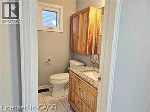 Bathroom with vanity and light tile patterned flooring - 486 Dicenzo Drive, Hamilton, ON - Indoor Photo Showing Bathroom