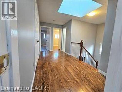 Corridor with a skylight and dark wood-style floors - 486 Dicenzo Drive, Hamilton, ON - Indoor Photo Showing Other Room