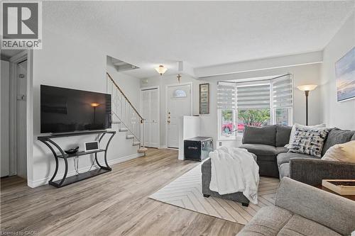 Living room with light wood-type flooring and a textured ceiling - 21 Greystone Crescent, St. Catharines, ON - Indoor Photo Showing Living Room