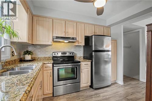 Kitchen featuring light wood finish cabinets, stainless steel appliances, light stone counters, and tasteful backsplash - 21 Greystone Crescent, St. Catharines, ON - Indoor Photo Showing Kitchen With Double Sink
