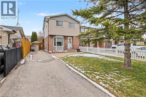 View of front facade with driveway and brick siding - 21 Greystone Crescent, St. Catharines, ON - Outdoor