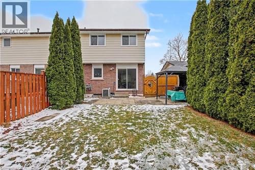 Snow covered property featuring brick siding, a fenced backyard, and a patio - 21 Greystone Crescent, St. Catharines, ON - Outdoor
