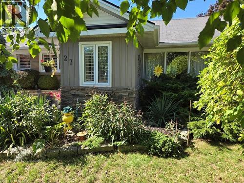 View of side of property featuring board and batten siding and stone siding - 27 Hepburn Avenue, St. Thomas, ON - Outdoor
