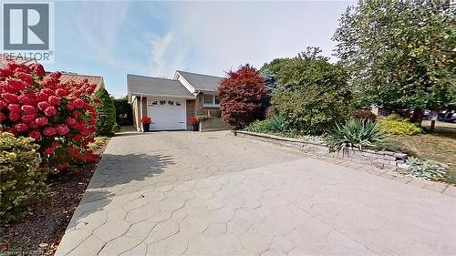View of front of home featuring driveway and an attached garage - 27 Hepburn Avenue, St. Thomas, ON - Outdoor