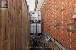 Rain barrel system at side of house - 
