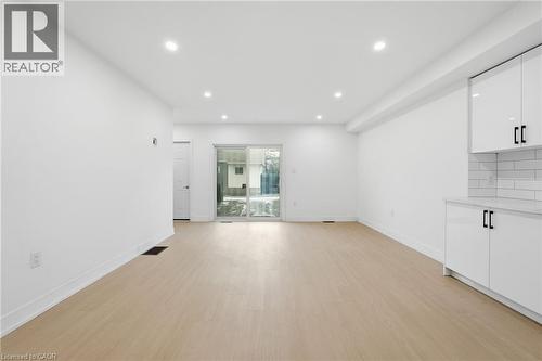 Unfurnished living room with light wood finished floors and recessed lighting - 1278 Main Street E, Hamilton, ON - Indoor Photo Showing Other Room