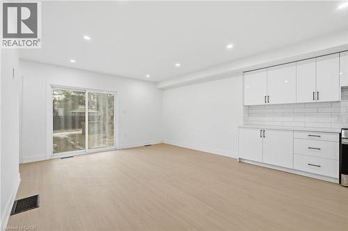 Unfurnished living room with light wood finished floors and recessed lighting - 1278 Main Street E, Hamilton, ON - Indoor