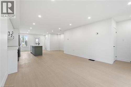 Unfurnished living room with light wood-type flooring and recessed lighting - 1278 Main Street E, Hamilton, ON - Indoor Photo Showing Other Room