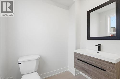 Half bathroom with toilet and vanity - 1278 Main Street E, Hamilton, ON - Indoor Photo Showing Bathroom