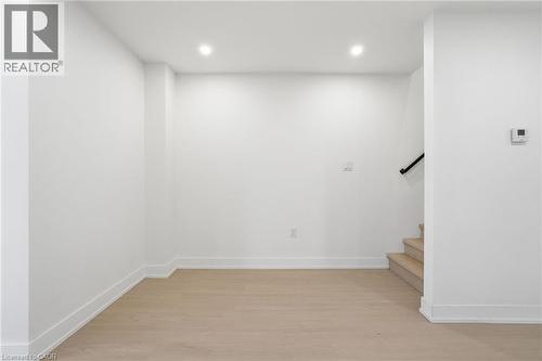 Staircase featuring wood finished floors and recessed lighting - 1278 Main Street E, Hamilton, ON - Indoor Photo Showing Other Room