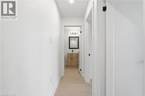 Hall featuring baseboards and light wood finished floors - 1278 Main Street E, Hamilton, ON - Indoor Photo Showing Other Room