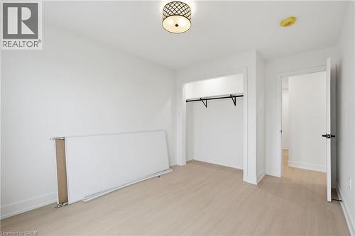 Unfurnished bedroom with light wood-style flooring and a closet - 1278 Main Street E, Hamilton, ON - Indoor Photo Showing Other Room