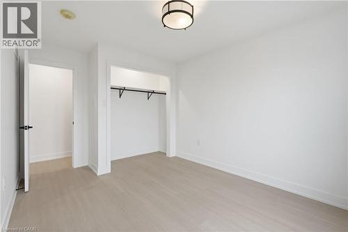 Unfurnished bedroom featuring a closet and light wood finished floors - 1278 Main Street E, Hamilton, ON - Indoor Photo Showing Other Room