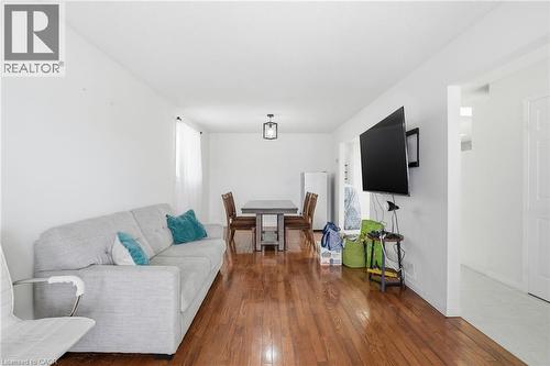 Living room featuring dark wood-style flooring and baseboards - 513 Rexford Drive, Hamilton, ON - Indoor Photo Showing Living Room