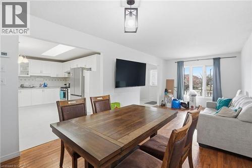 Dining room with dark wood-style floors and a skylight - 513 Rexford Drive, Hamilton, ON - Indoor Photo Showing Other Room